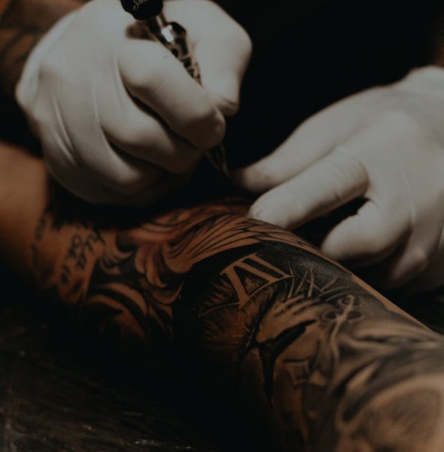 A tattoo artist at work, from Ink-Eeze